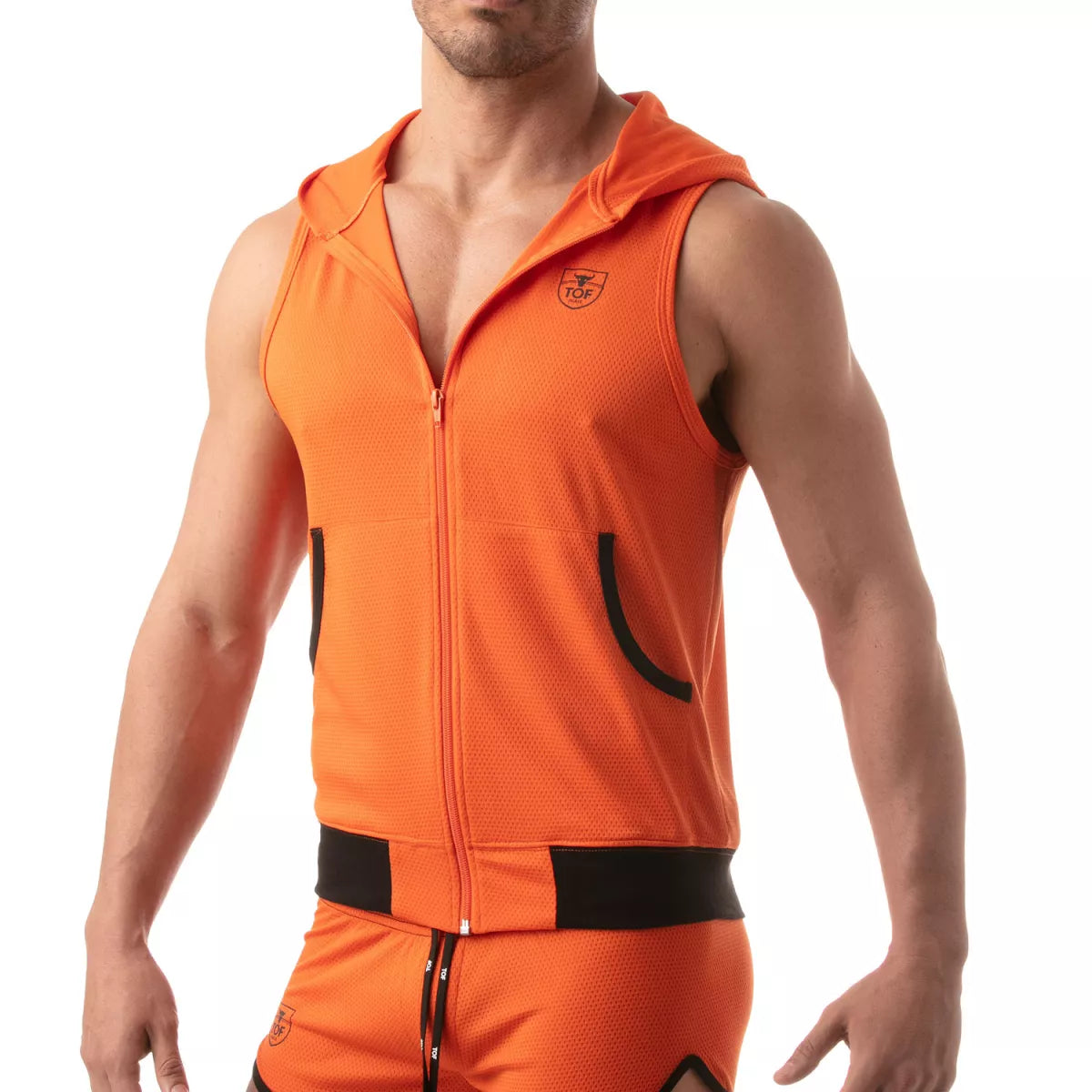 TOF's ultra-light sleeveless hooded jacket is made of polyester microfiber fabric.  This hoodie has pockets, zipper front, and TOFs iconic logo over the chest.